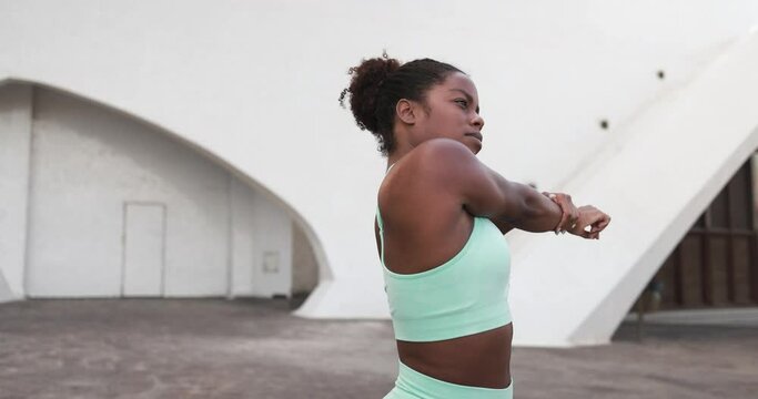 Fit african girl doing sport stretching exercise outdoor