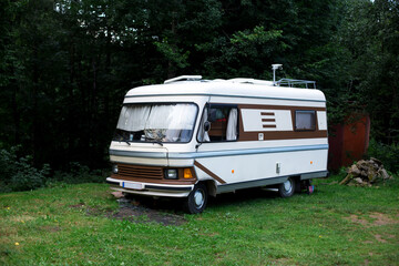 old fashioned retro camper automobile in green environment