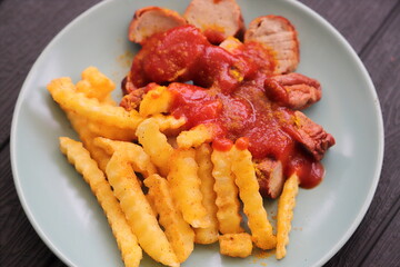 delicious sausage with french fries and curry sauce