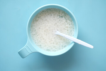 Close up of baby food in a bowl on floor 