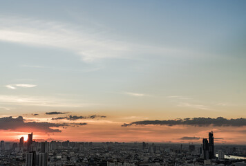 Gorgeous panorama scenic of the sunrise with cloud on the orange sky over large metropolitan city in Bangkok. Copy space, Selective focus.