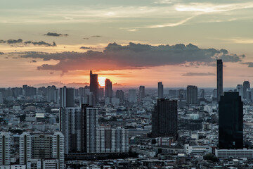 Gorgeous panorama scenic of the sunrise with cloud on the orange sky over large metropolitan city in Bangkok. Copy space, Selective focus.