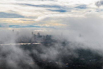 Bangkok, thailand -Sep 16, 2021 : An impressive aerial top view of skyscrapers at downtown Bangkok city along the chao phraya river in morning fog. No focus, specifically.