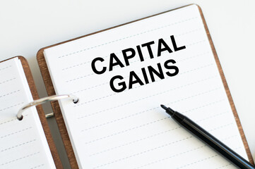 notebook with text Capital Gains on the table. Financial and concept photo