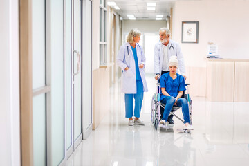 Professional medical doctor team with stethoscope in uniform discussing with patient woman with cancer cover head with headscarf of chemotherapy cancer in hospital.health care concept