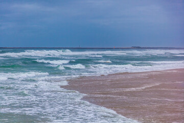 Ocean shore, sandy beach and waves. Beautiful landscape, Portugal
