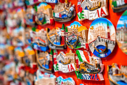 Colorful travel destination magnet souvenirs displayed in a row to sell to tourists
