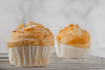 Delicious modern cruffins are made from layered croissants in the shape of a muffin Shaped like a cupcake. topping almond.