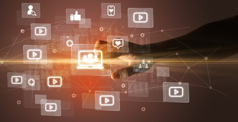 Hand pressing social media multimedia application screen with media icons on futuristic concept