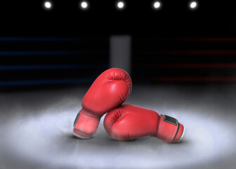 Pair of boxing gloves on ring in darkness