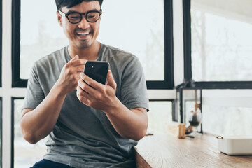 asian man work using cell phone hand holding mobile texting message contact us.chatting,search...