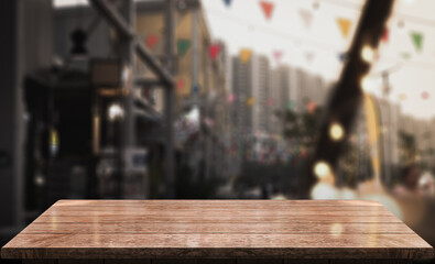 Empty wooden table top with lights bokeh on blur restaurant background.