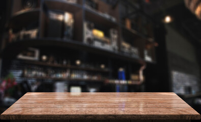 Empty wooden table top with lights bokeh on blur restaurant background.