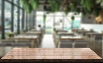 Empty wooden table top with lights bokeh on blur restaurant background.