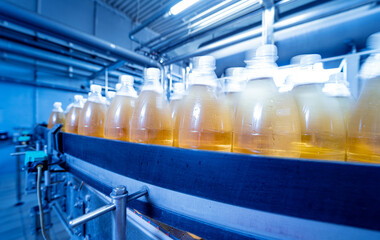 Conveyor belt with bottles for juice or water at a modern beverage plant