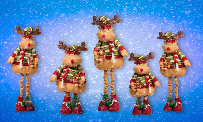 Christmas reindeers (toy)  on blue background with snow