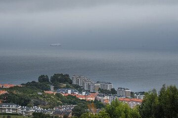 Castro Urdiales houses with the sea and the fog in the background