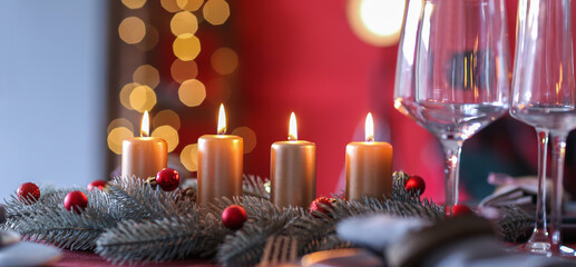 Beautiful table setting with Christmas candles in room