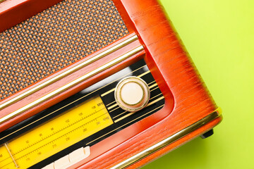 Vintage radio receiver on color background