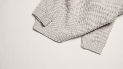 Beige sweater on light. Decoration concept. 