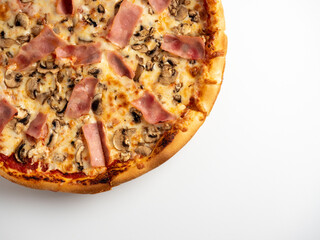 Close-up pizza with ham and mushrooms on a white background. A traditional Italian dish. A delicious and unhealthy dish. Top view, flat lay, copy space