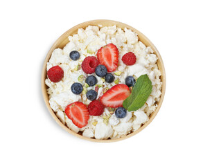 Fresh cottage cheese with berries and mint in bowl isolated on white, top view