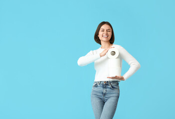 Young woman with toilet paper on color background