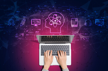 Obraz na płótnie Canvas Online education concept with person using a laptop computer