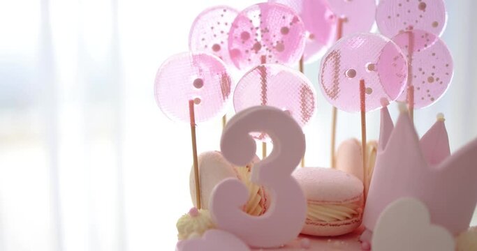 decorated birthday cake with hearts, crown and sugar beads for three years old baby girl