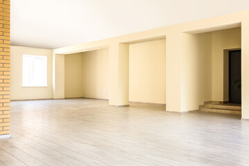 View of big empty office with beige walls and window