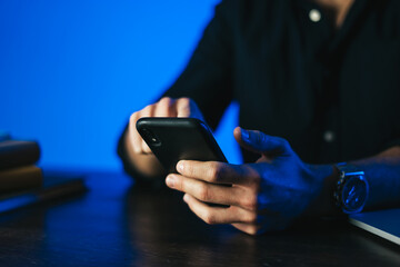 Man pointing on smartphone screen, chatting in social networks, meeting website, searching internet, sending sms, using text messenger or online banking. Remote work
