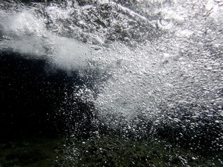 Air bubbles in the water background.Abstract oxygen bubbles in sea.Water bubbles isolate on black background.Black and white tone style, Air bubbles underwater rising to water surface, natural scene.