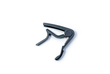Matte black capo for acoustic and classical guitar isolated on white background.