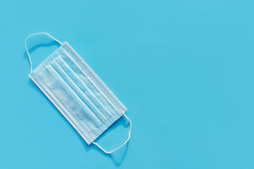 Ear loop face mask layers, protective masks on a blue background. dust protection respirator and respiratory medical respiratory mask