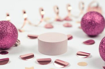 Podium with New Year's decor, with pink balls, confetti and garlands. Christmas scene for...
