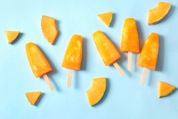 Tasty melon popsicles on color background