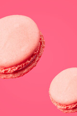Sweet macarons or macaroons, flavored cookies floating in the air