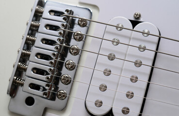 A fragment of a white electric guitar.