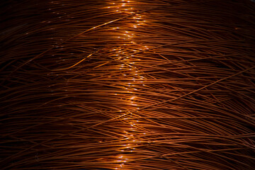 Enameled copper wire wound on a large spool.
