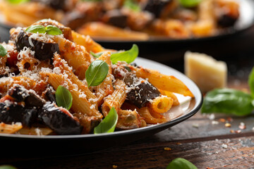 Pasta alla Norma with eggplant or aubergine, tomato, parmesan and basil. Healthy food