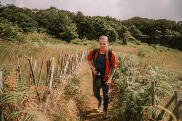 Man traveler walking by trail in jungle forest