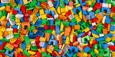 Heap of colorful toy plastic bricks and blocks