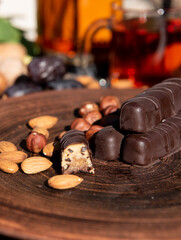Chocolate on the brown plate. Copy space. Close up.Sunshine outside. 