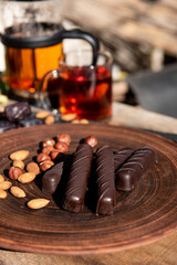 Chocolate on the brown plate. Copy space. Close up.Sunshine outside. 