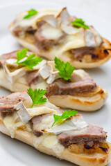 baguette baked with meat, onion and cheese