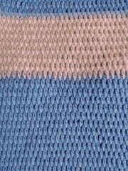 Textured knitting pattern in blue and white color. 