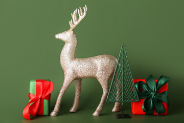Golden reindeer with Christmas gifts on green background
