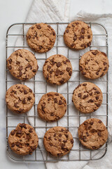 Freshly baked homemade cookies with dark chocolate on a marble background. A festive treat. The concept of home baking. Selective focus, top view