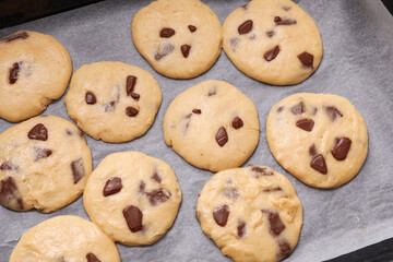 Baking tray with uncooked cookies on table, closeup