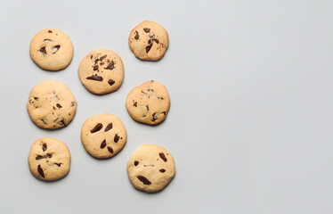 Delicious homemade cookies with chocolate chips on light background